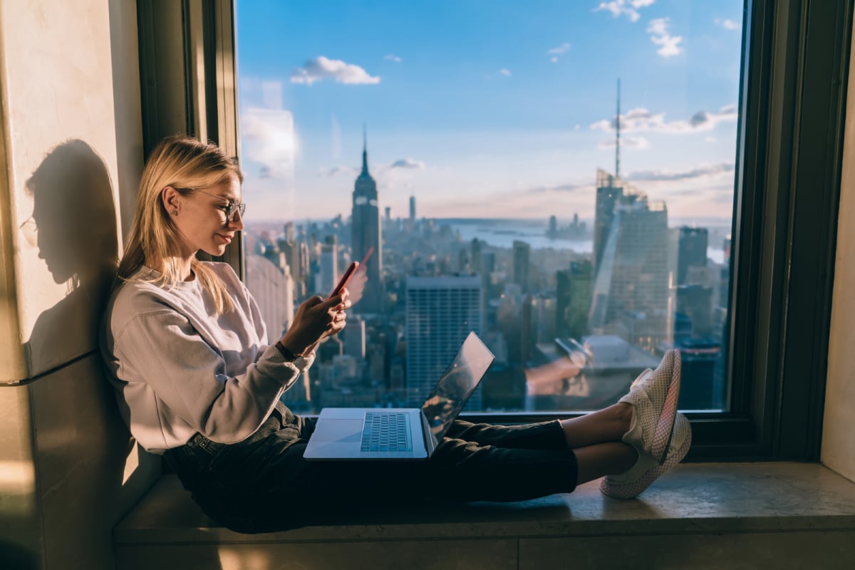 Woman Working on Laptop in Front of Empire State Building NYC